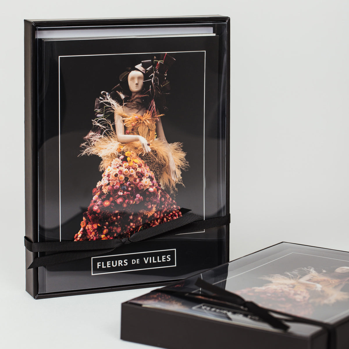 Greeting card  box with a woman in a floral dress with the 'Fleurs de Villes' logo on a white background.
