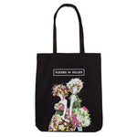 Black tote bag with floral mannequin designs and 'Fleurs de Villes' text on a white background