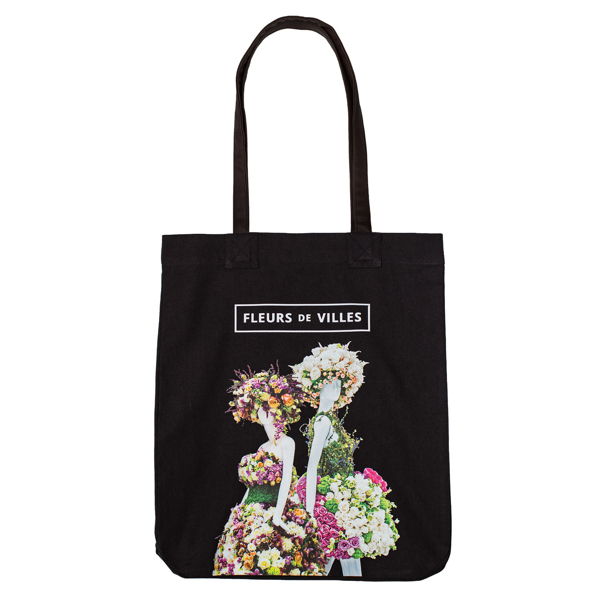 Black tote bag with floral mannequin designs and 'Fleurs de Villes' text on a white background